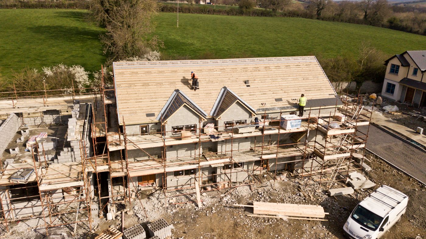 UK new build housing site under construction with scaffolding